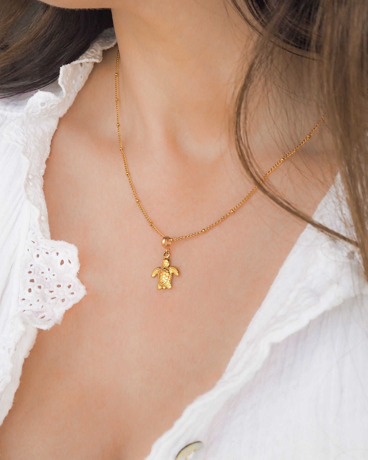 Model wearing Turtle Necklace made with Gold Stainless Steel