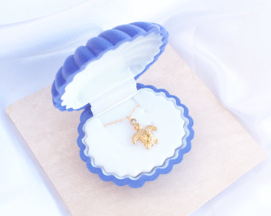 Blue Velvet Seashell Jewelry Box with Gold Baby Turtle Necklace, Shell shaped jewelry box blue velvet seashell jewellery box on stone displayed