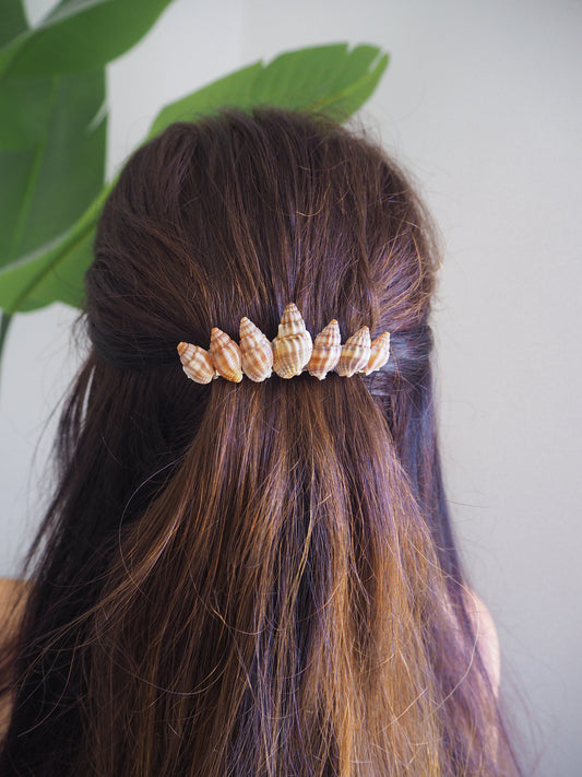 Model wearing Netted Dog Whelk Shells Hair Clip Barrette on stone displayed, Boho Seashell Beach Clip from Portugal, Handpicked Real Shells, Seashell Hair Decoration, Bohemian Seashell Wedding Hair accessories, Coastal Christmas gift, Beach Wedding Hair