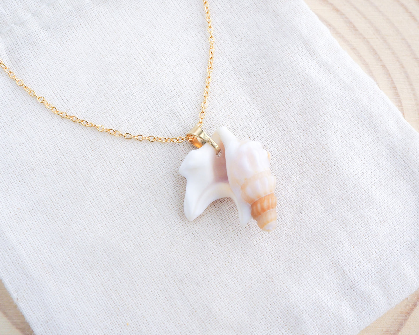 Brown Pelicans Foot Shell Gold Necklace backside on display