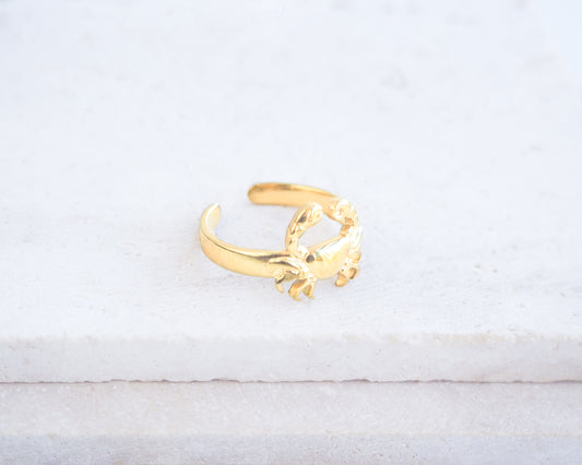 Side view of Gold Cancer Zodiac Ring on stone displayed, adjustable 18k gold stainless steel crab ring