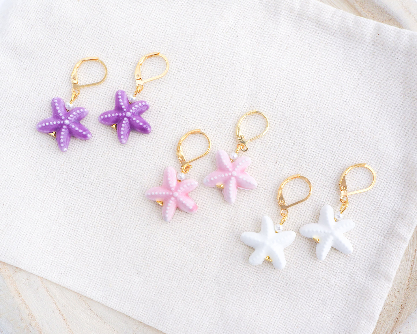 Mix of Ceramic Starfish Gold Earrings on display, Purple White Pink Sea Star Summer earrings