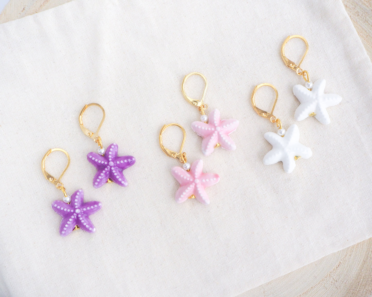 Mix of Ceramic Starfish Gold Earrings on display, Pink Purple White Sea Star Summer earrings