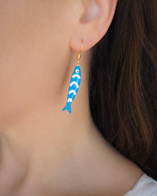 Close up of Blue Sardine Fish Earrings with 14k gold stainless steel hooks in ear of model, Beautiful gift for Portugal lovers or holiday memory, coastal jewelry from Portugal