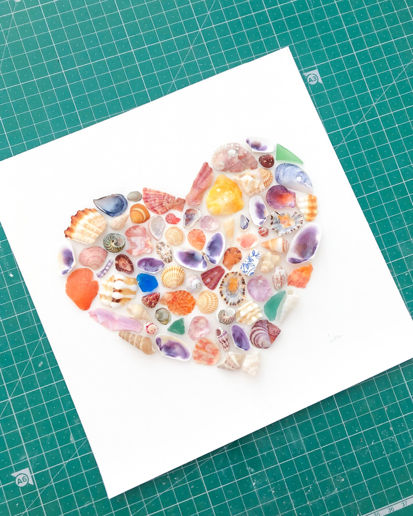 Creation of Rainbow Seashell Heart Artwork with colorful shell handpicked from Portugal with green background. Coastal Home Wall Decor, Shell Wall Art, Handmade Shell Artwork, Cute Coastal Nursery Decoration