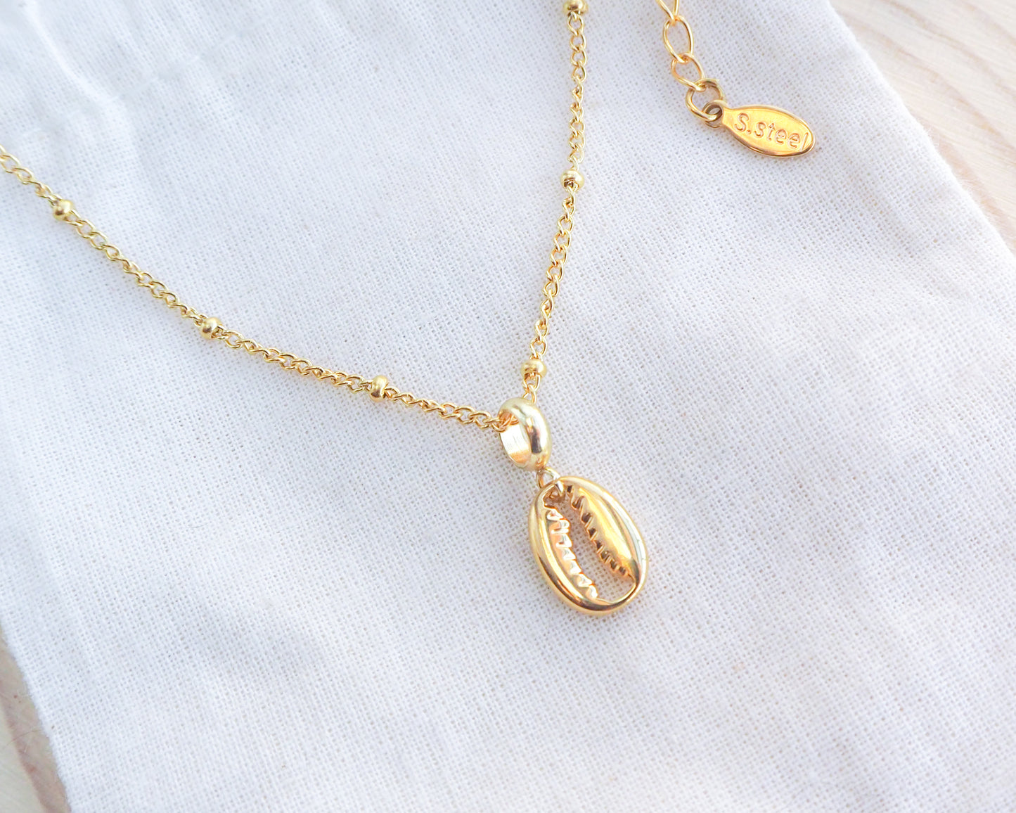 Gold Cowrie Necklace on display