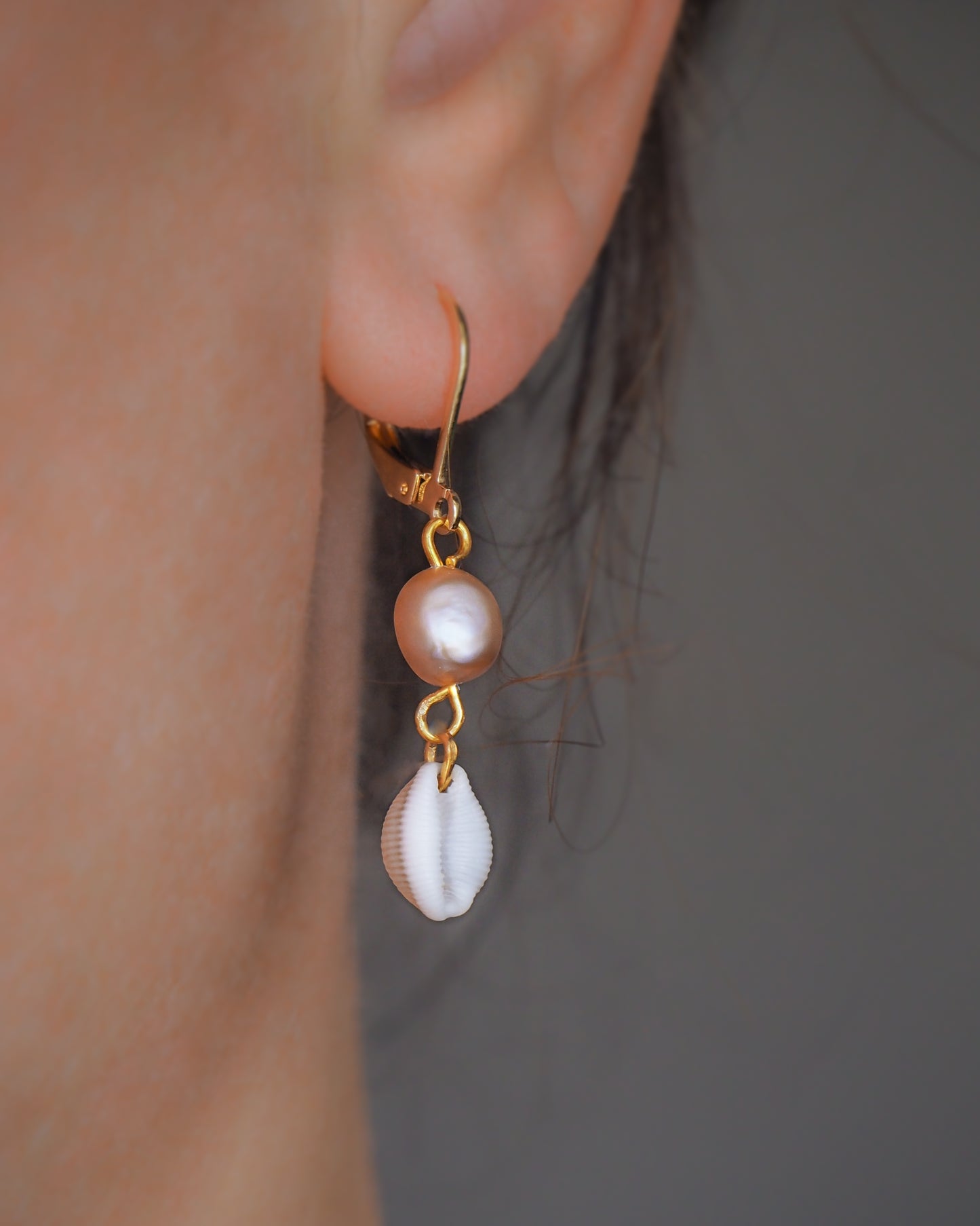 Cowrie Freshwater Pearl Gold Earring close up in ear model