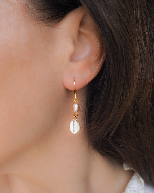 Model wearing Gold Tiny Cowrie Seashell Wedding Earrings with Rose Freshwater Pearl, Trendy Shell Beach Shell Drop Earrings