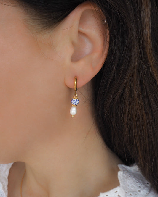 Dainty Azulejo Pearl Earrings from Portugal in ear model, Portuguese Ceramic Tile Jewelry on display