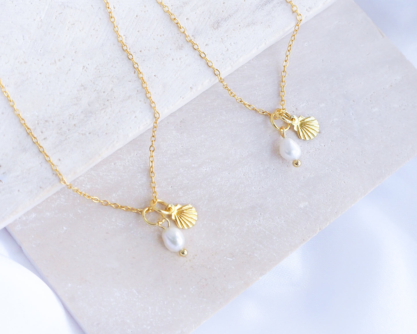Dainty Gold Shell Pearl Necklaces on stone with freshwater pearls and 18k gold dainty shell pendants