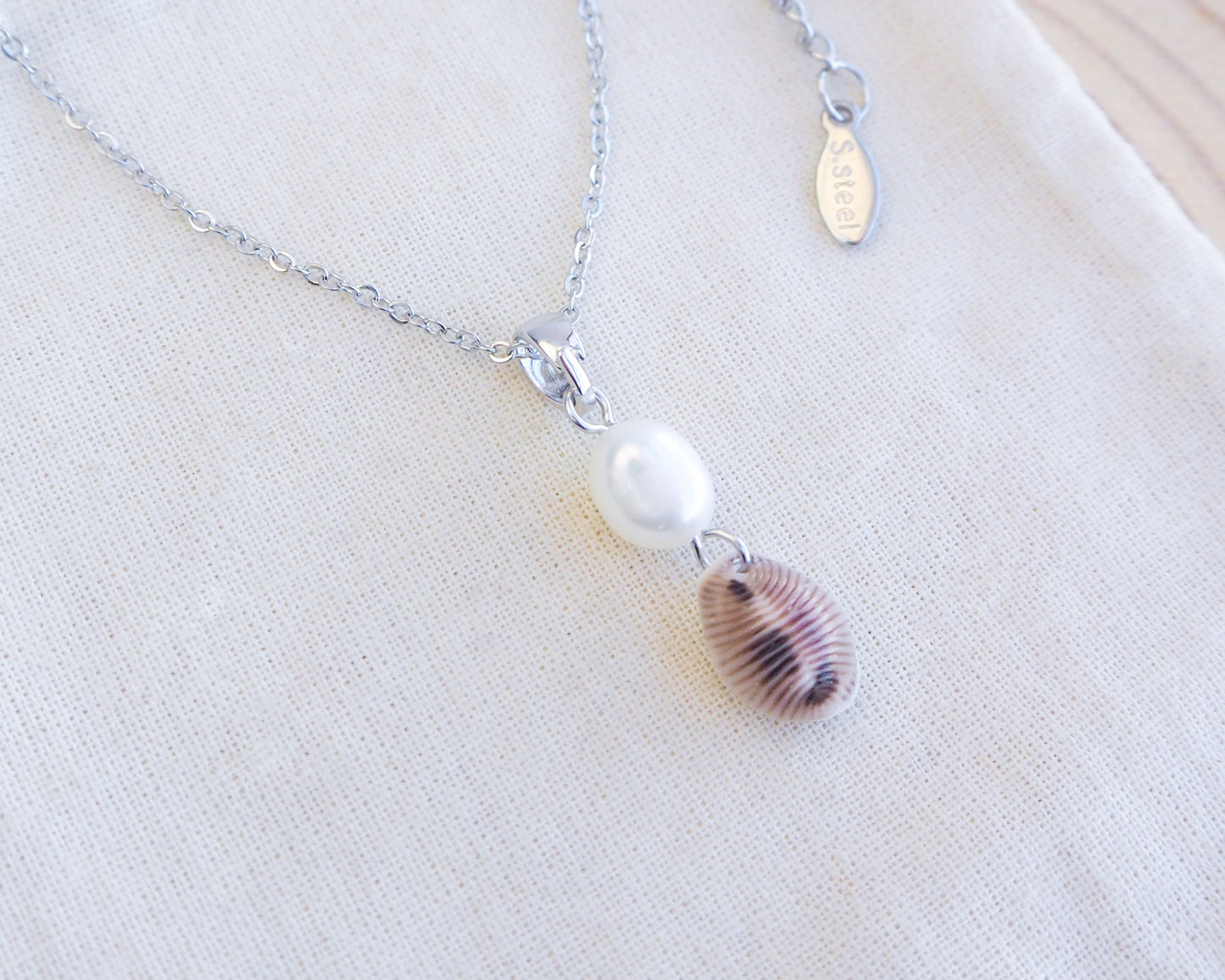 European Cowrie Shell Pearl Silver Necklace on display