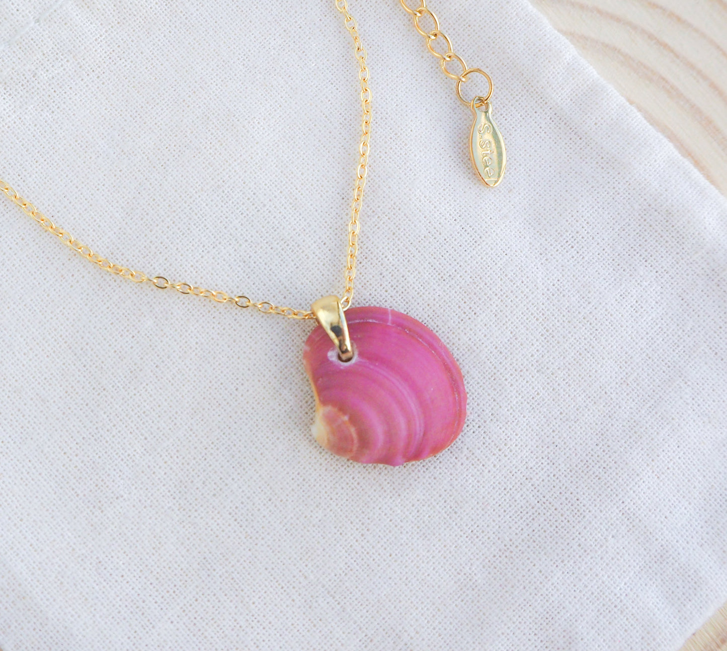 Fuchsia Pink Venus Shell Necklace on display