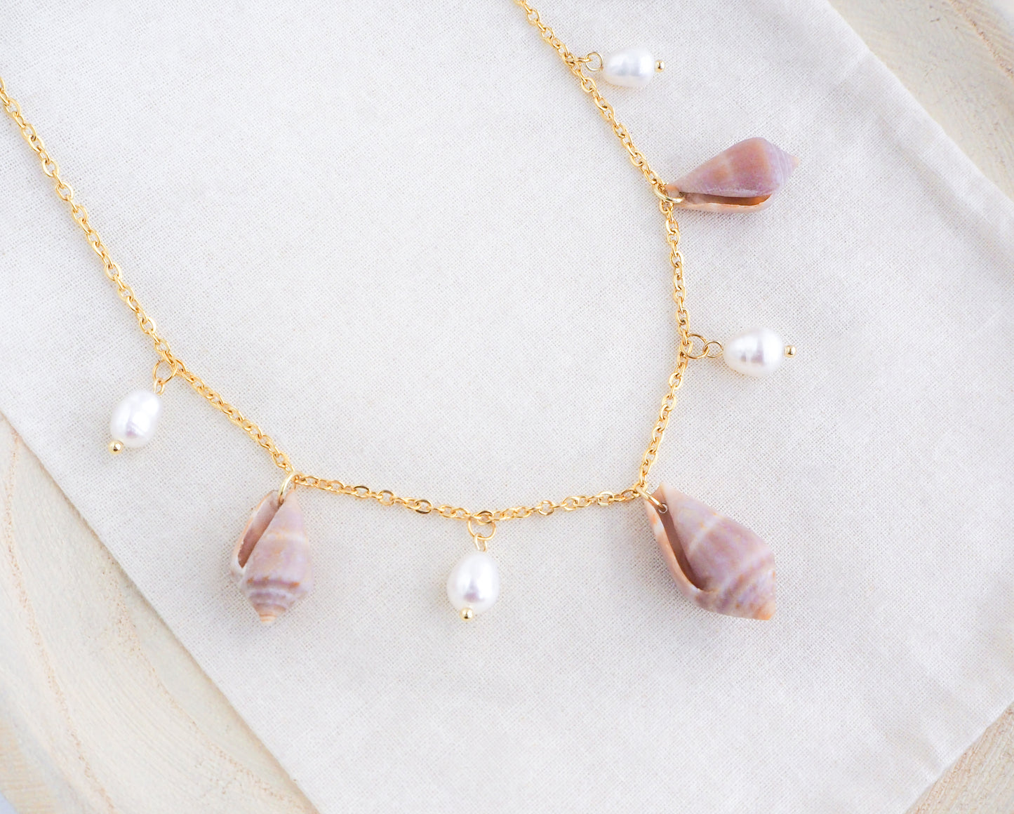 Gold Mediterranean Cone Shell with Pearl Charm Necklace on display back side