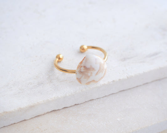 Side view of Norwegian Cockle Shell Gold Ring on stone, 18k gold stainless steel adjustable ring, handpicked cockle shell from Portugal