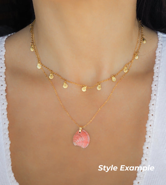 Model with pink venus shell gold necklace and tiny shell charm necklace handmade from Portugal
