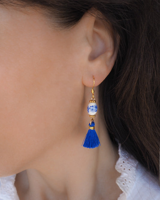 Gold Portuguese Tile Earrings with Royal Blue Silk Accents in ear model
