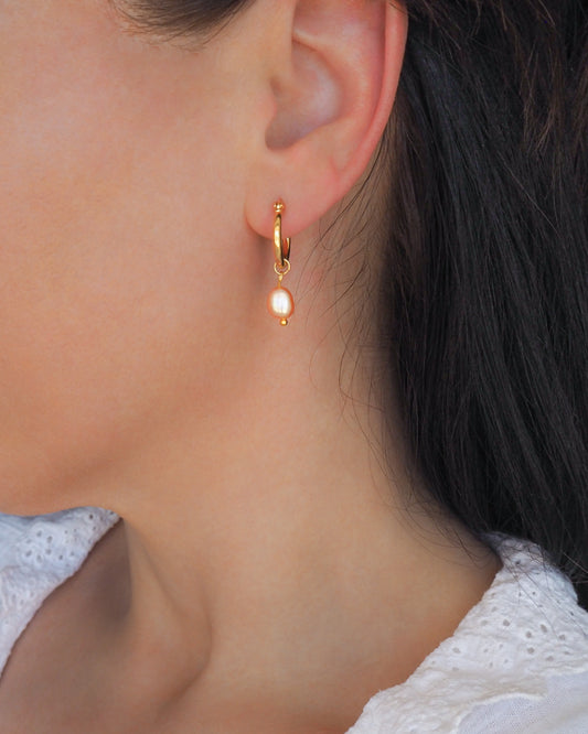 Gold Rose Freshwater Pearl earrings in ear model