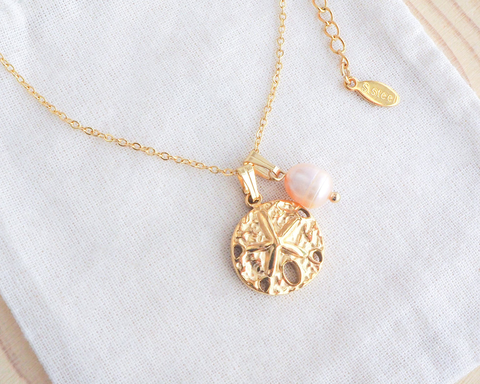 Gold Sand Dollar Rose Freshwater Pearl Necklace on display