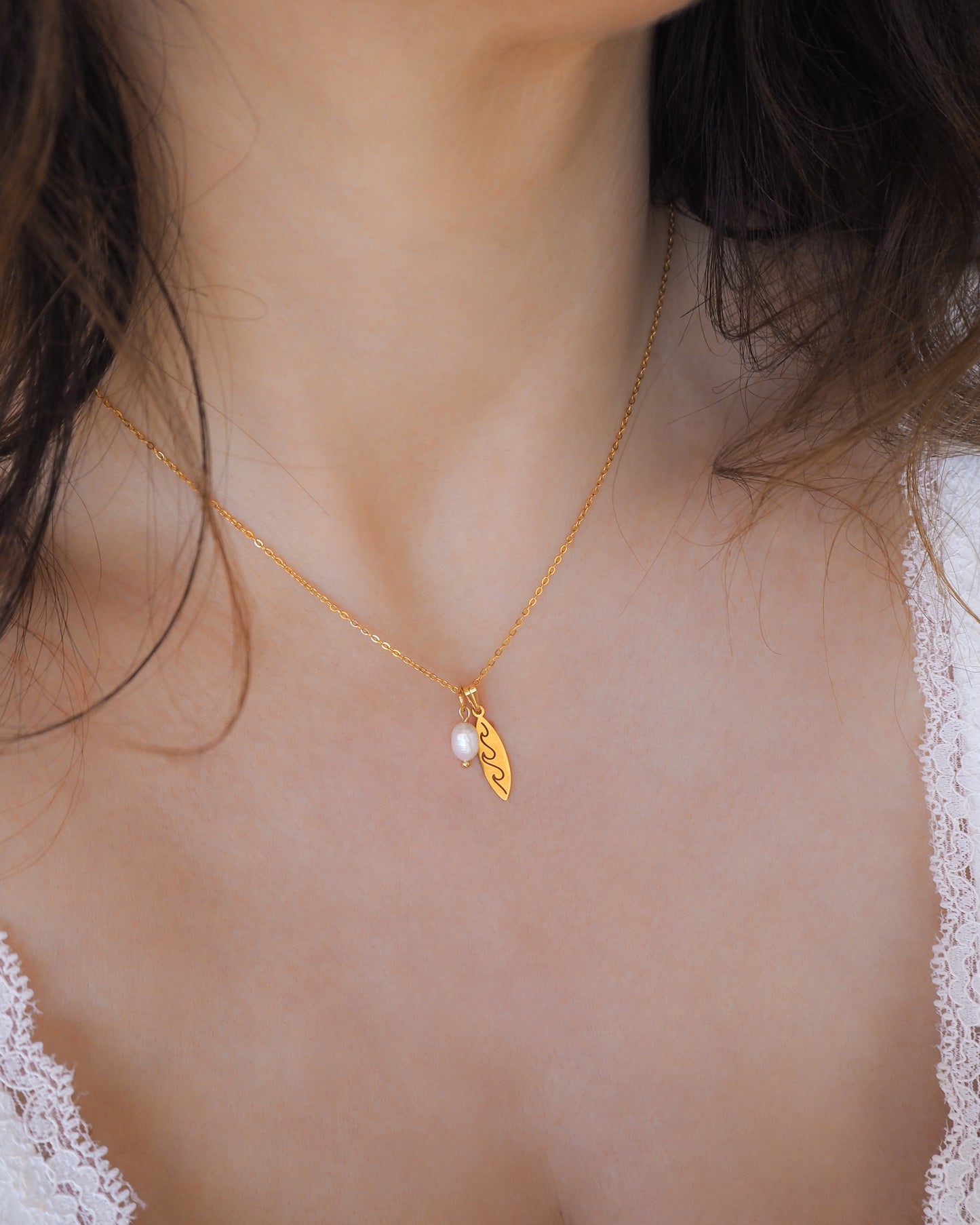 Gold Surfboard Pearl Necklace on neck model