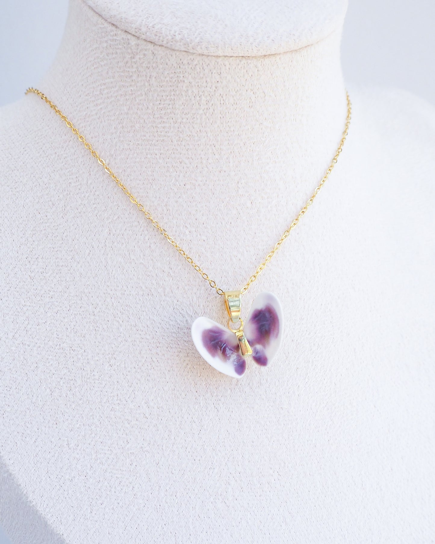 Tiny Purple White Coquina Butterfly Shells Gold Necklace on display neck