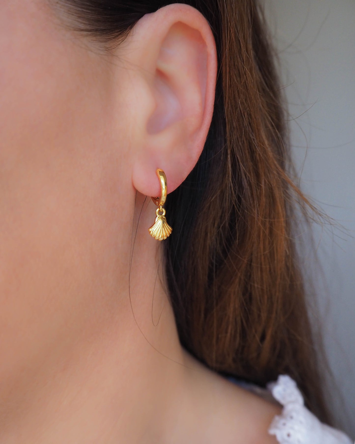 Model wearing Gold Tiny Seashell Huggie Earrings, 14k gold vermeil or 925 Sterling Silver, Dainty Tiny Scallop Shell Pendant Hoop Earrings, Sea by Lou jewelry, Minimalistic Coastal Style