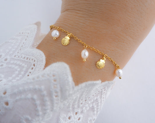 Gold Tiny Shell Ivory White Freshwater Pearl Bracelet on wrist model, Dainty Gold Shell Bracelet