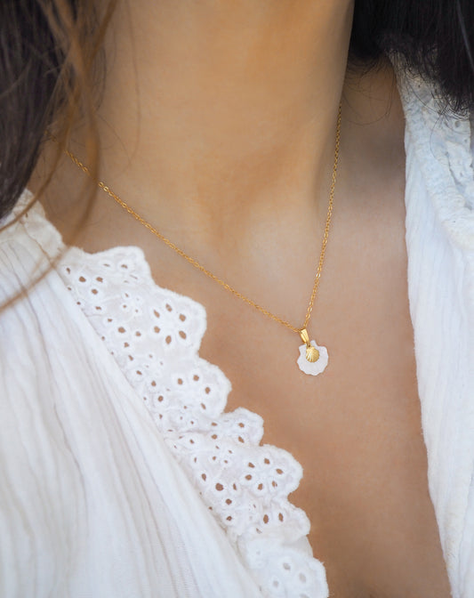 Gold Shell Mother of Pearl Necklace on model, dainty tiny gold shell with mother of pearl pendant.