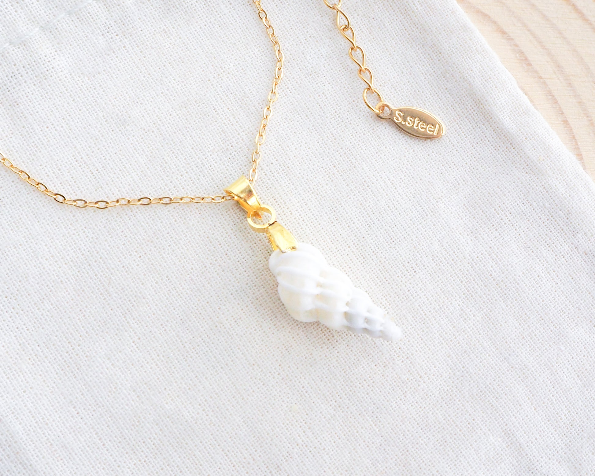 Gold Tiny White Wentletrap Necklace backside on display