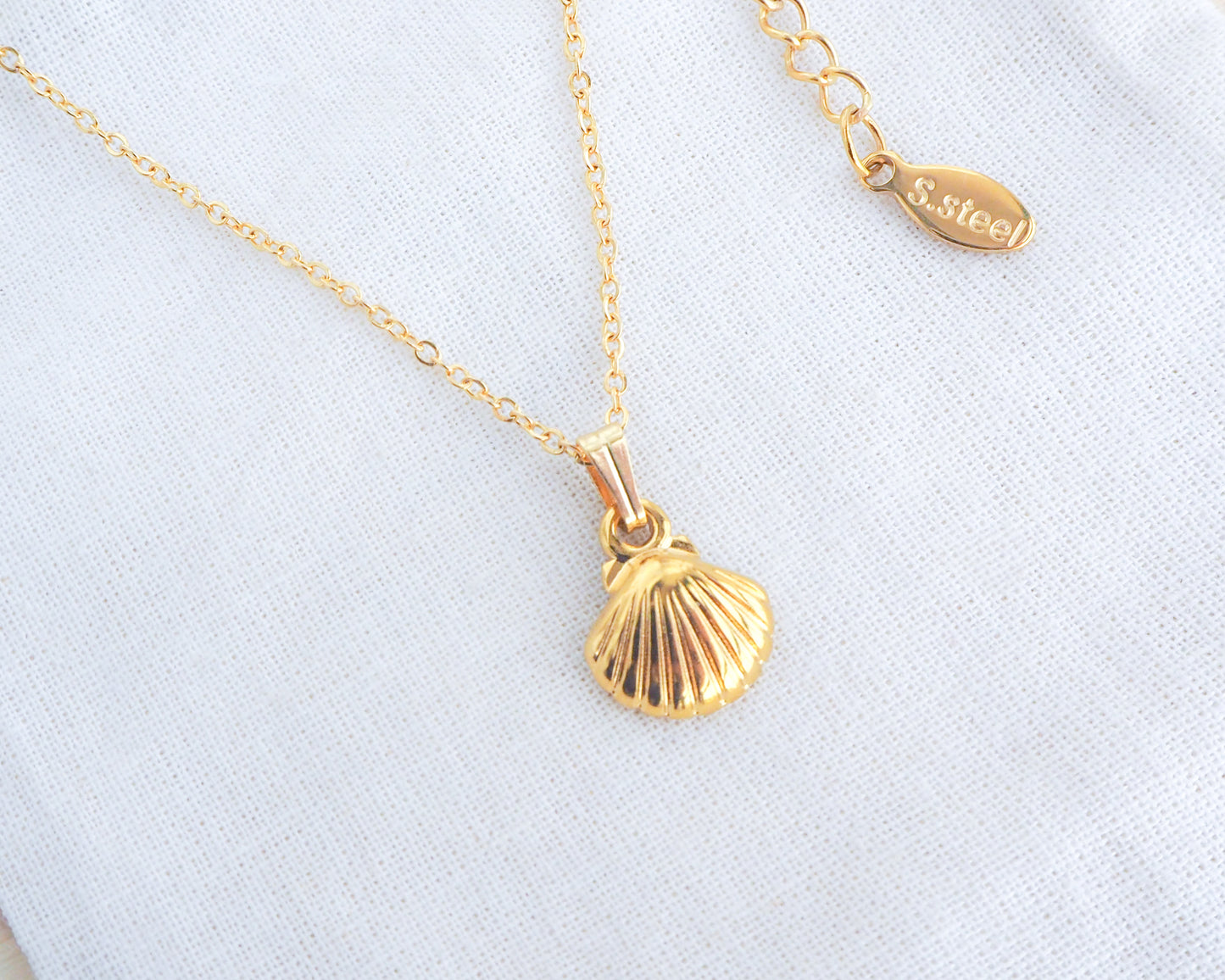Gold tiny shell pendant close up classic clasp