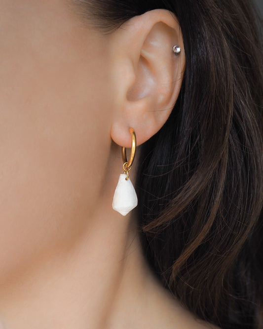 Model wearing Light Mediterranean Cone Shell Gold Earring Hoops, handpicked cone shells from Portugal, 18k gold stainless steel shell earring hoops, seabylou