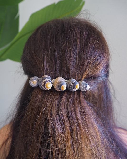 Model wearing Lined Top Shells Hair Clip Barrette with green plant background, Seashell Beach Clip from Portugal, Handpicked Real Shells, Seashell Hair Decoration, Mermaid Wedding Hair Assocciares, Coastal Christmas gift, Beach Wedding Hair