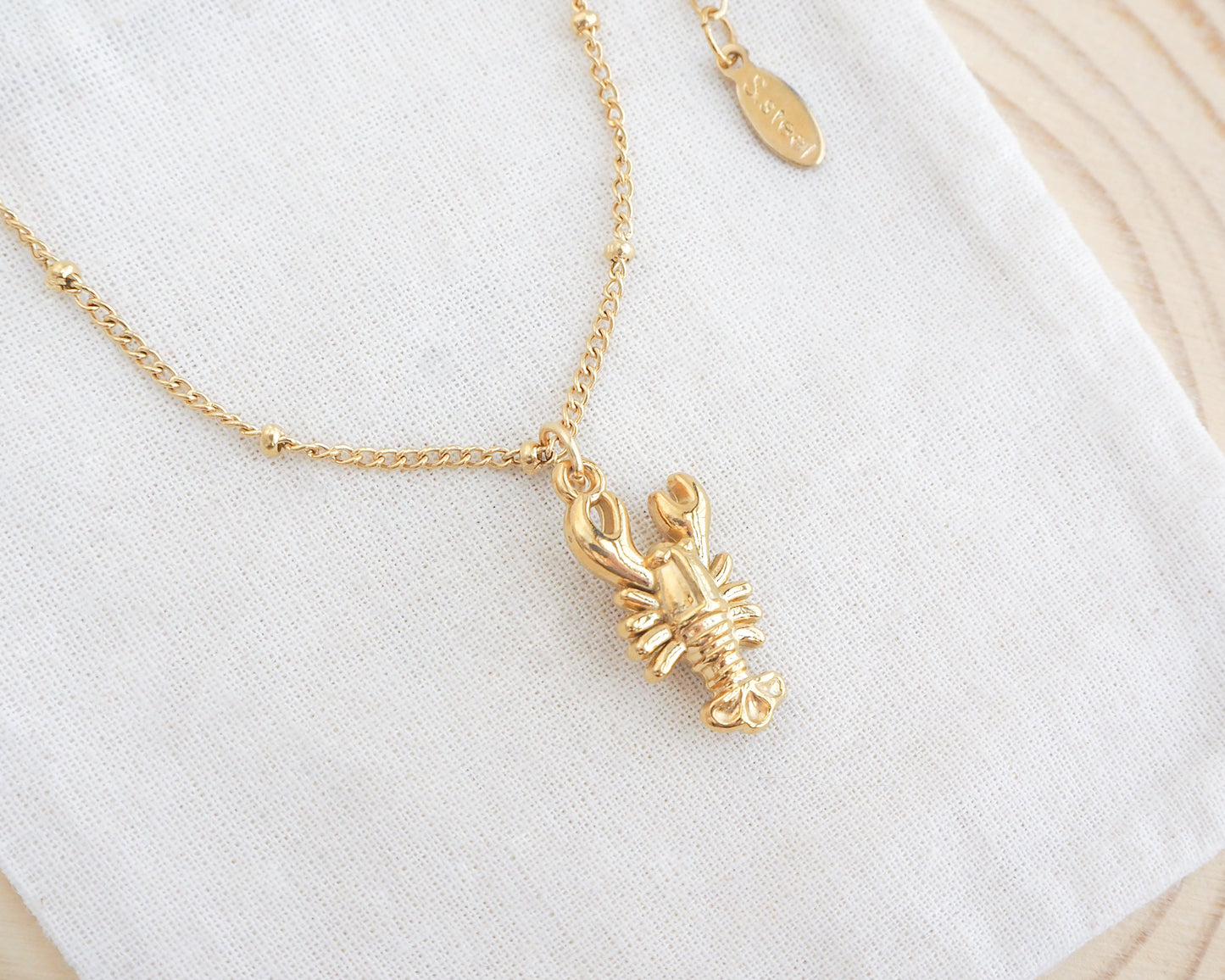 Gold Lobster Necklace display made with 18k gold stainless steel, coastal jewelry from Portugal