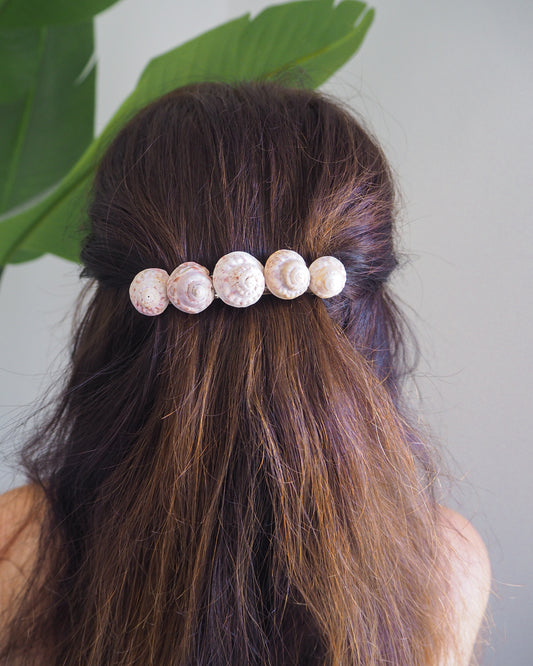 Model wearing Magus Top Shells Hair Clip Barrette with green plant background, Seashell Beach Clip from Portugal, Handpicked Real Shells, Seashell Hair Decoration, Mermaid Wedding Hair Assocciares, Coastal Christmas gift, Beach Wedding Hair
