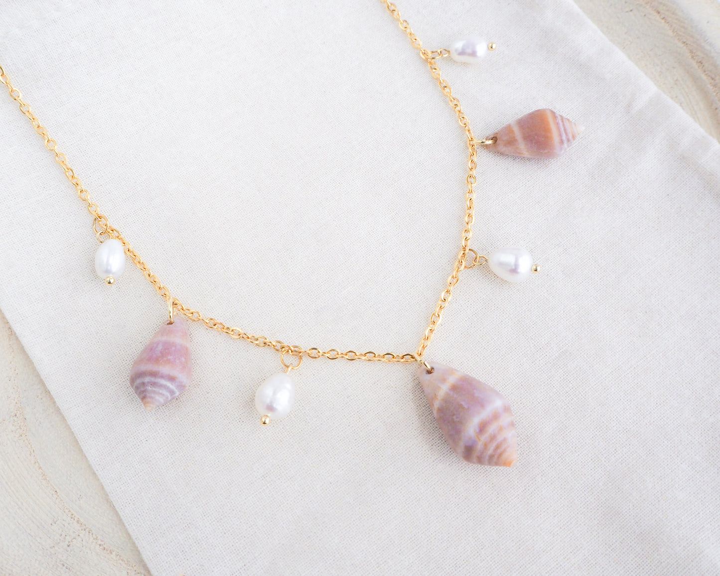 Mediterranean Cone Shell with Pearl Charm Necklace front side on display, Cone Shells from Portugal with freshwater Pearls