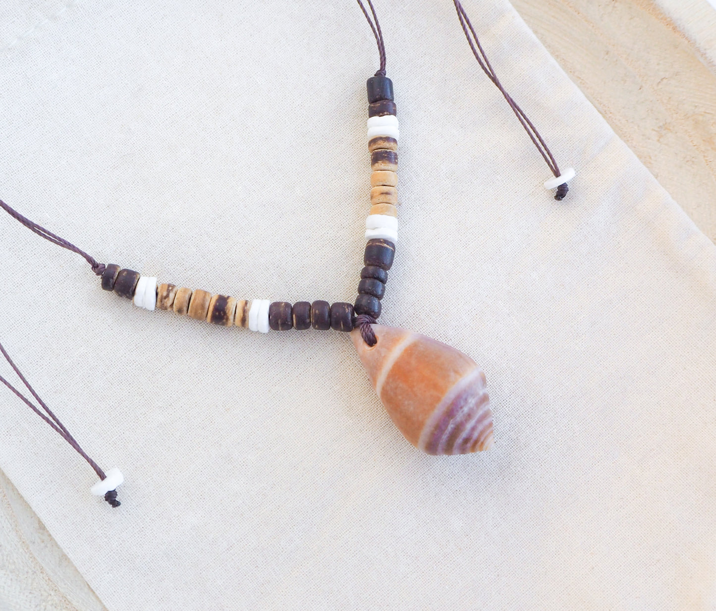 Cone Shell Surf Necklace with Coconut Wooden beads on display