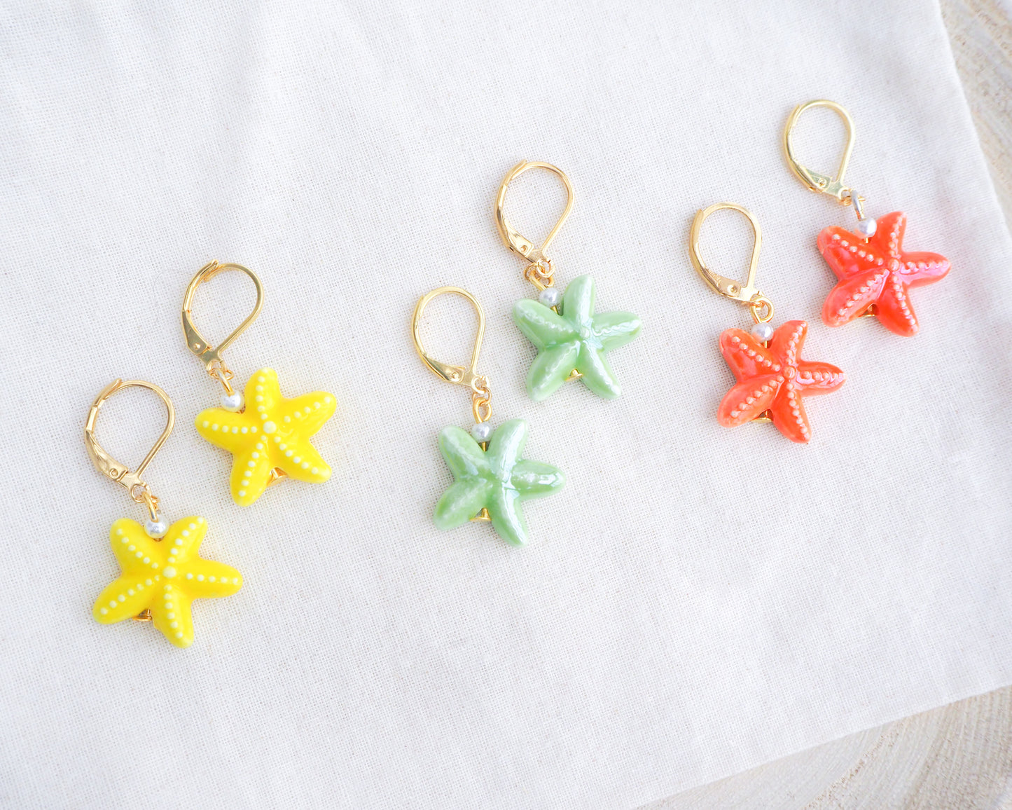 Mix of Ceramic Starfish Sea Star Gold Earrings on display, Yellow Green Orange Starfish Summer earrings