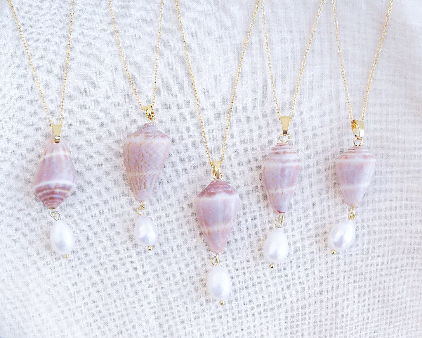 Mix of Mediterranean Cone Shell Pearl Necklaces Reversed from Portugal displayed, handpicked cone shell from Algarve, Freshwater pearl and 18k gold stainless steel chain