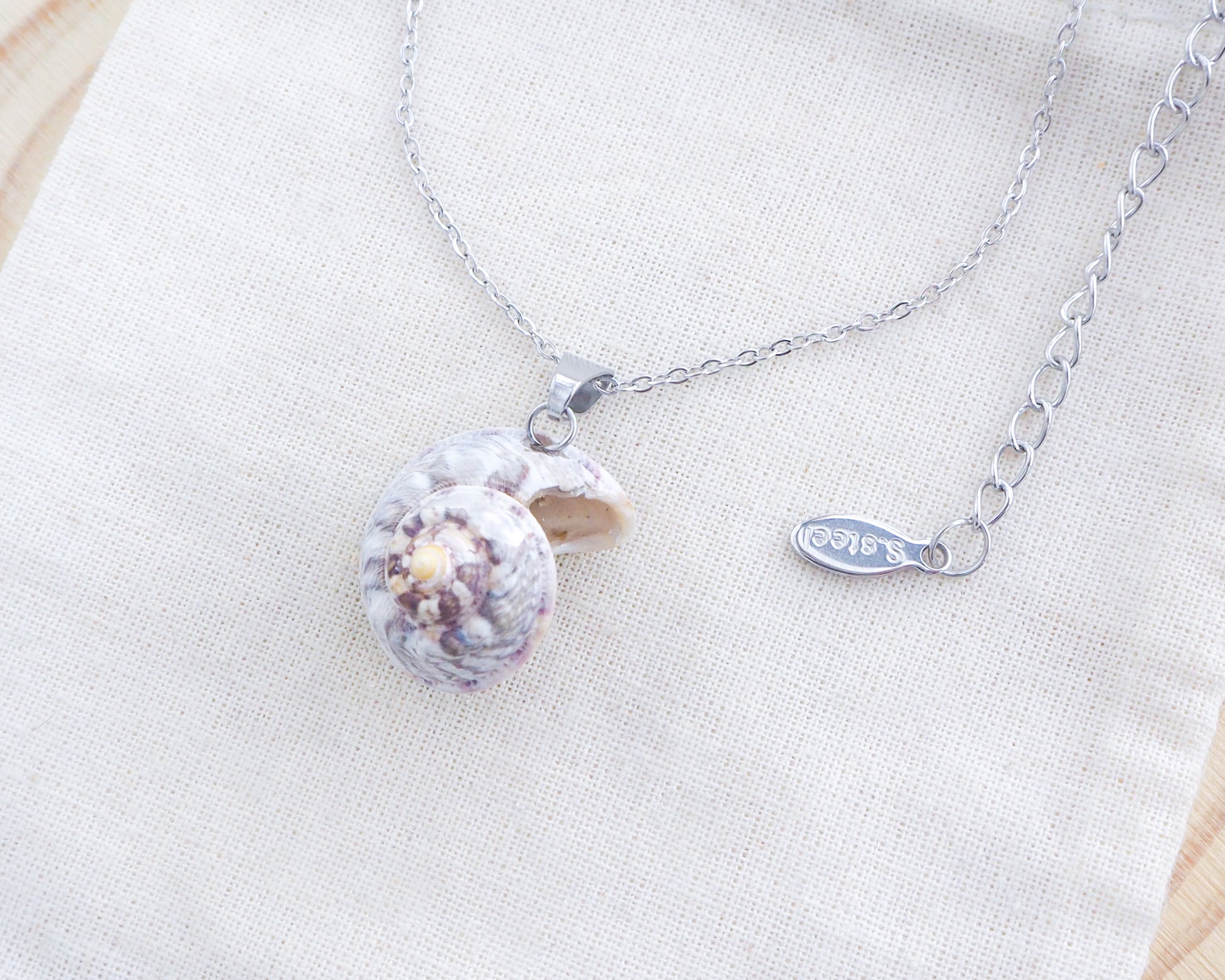 Pearly Magus Top Shell Silver Necklace on display