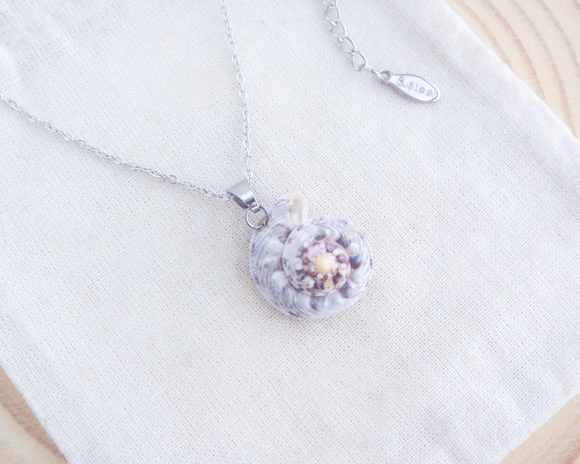 Pearly Silver Magus Top Shell Necklace on display