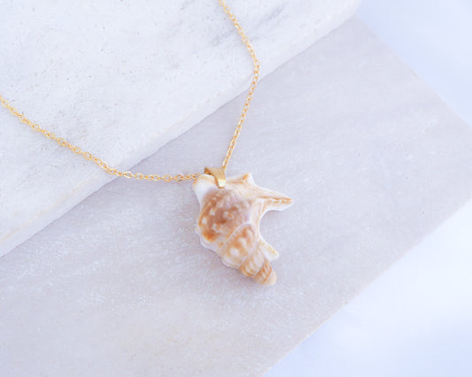 Pelicans Foot Gold Necklace from Portugal on stone