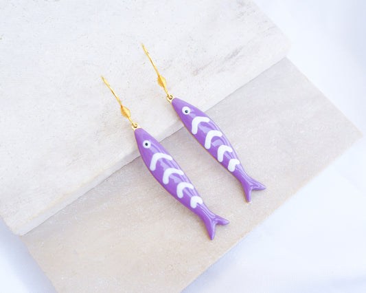 Purple Sardine Fish Earrings with 14k gold stainless steel earring hooks displayed on stone, Beautiful gift for Portugal lovers or holiday memory, coastal jewelry from Portugal