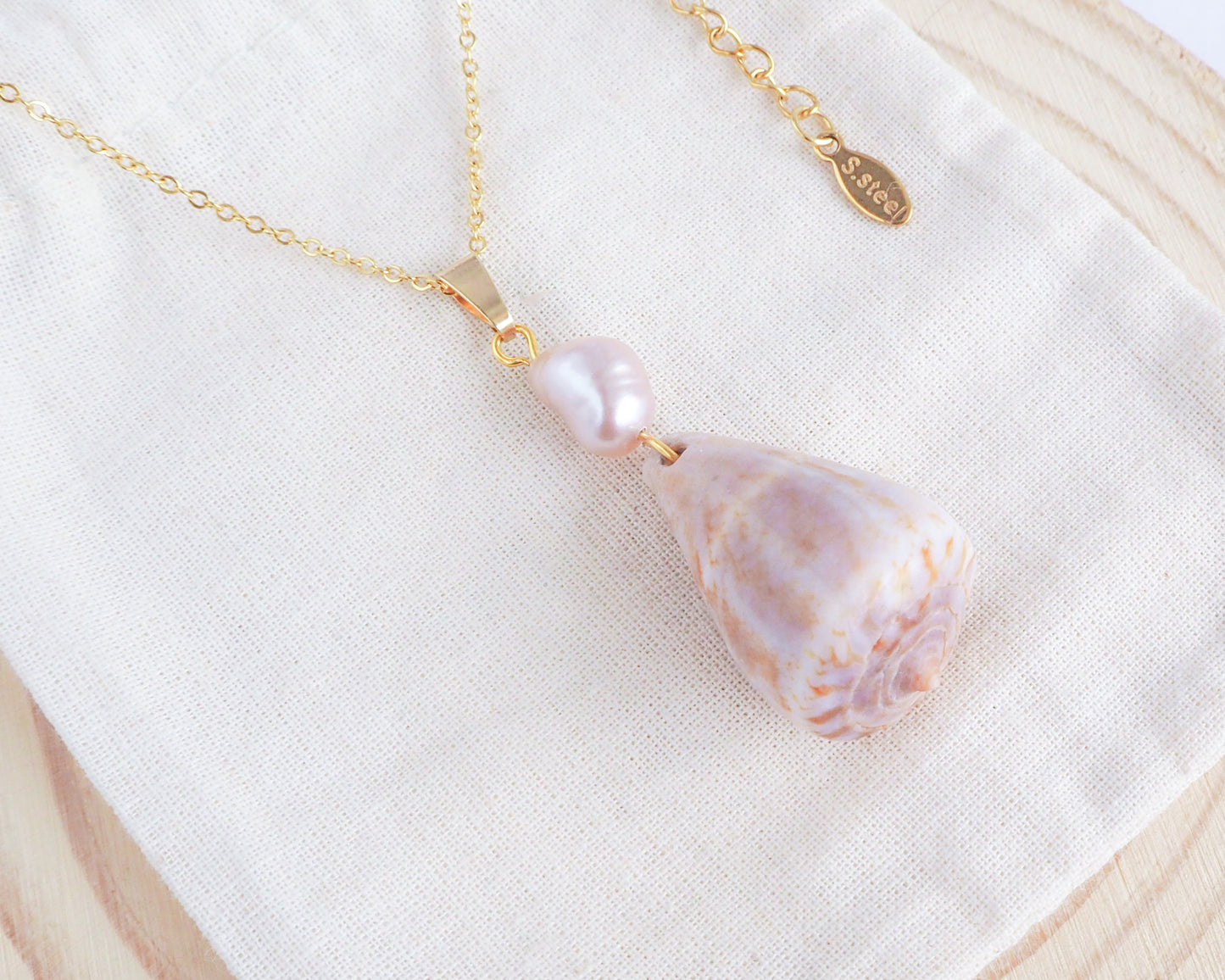 Rose Pearl Cone Shell Necklace on display