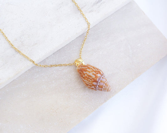 Rustic Dove Shell Gold Necklace on display, Detailed view of the Rustic Dove pendant, showcasing its natural patterns and coastal elegance. Sea By Lou