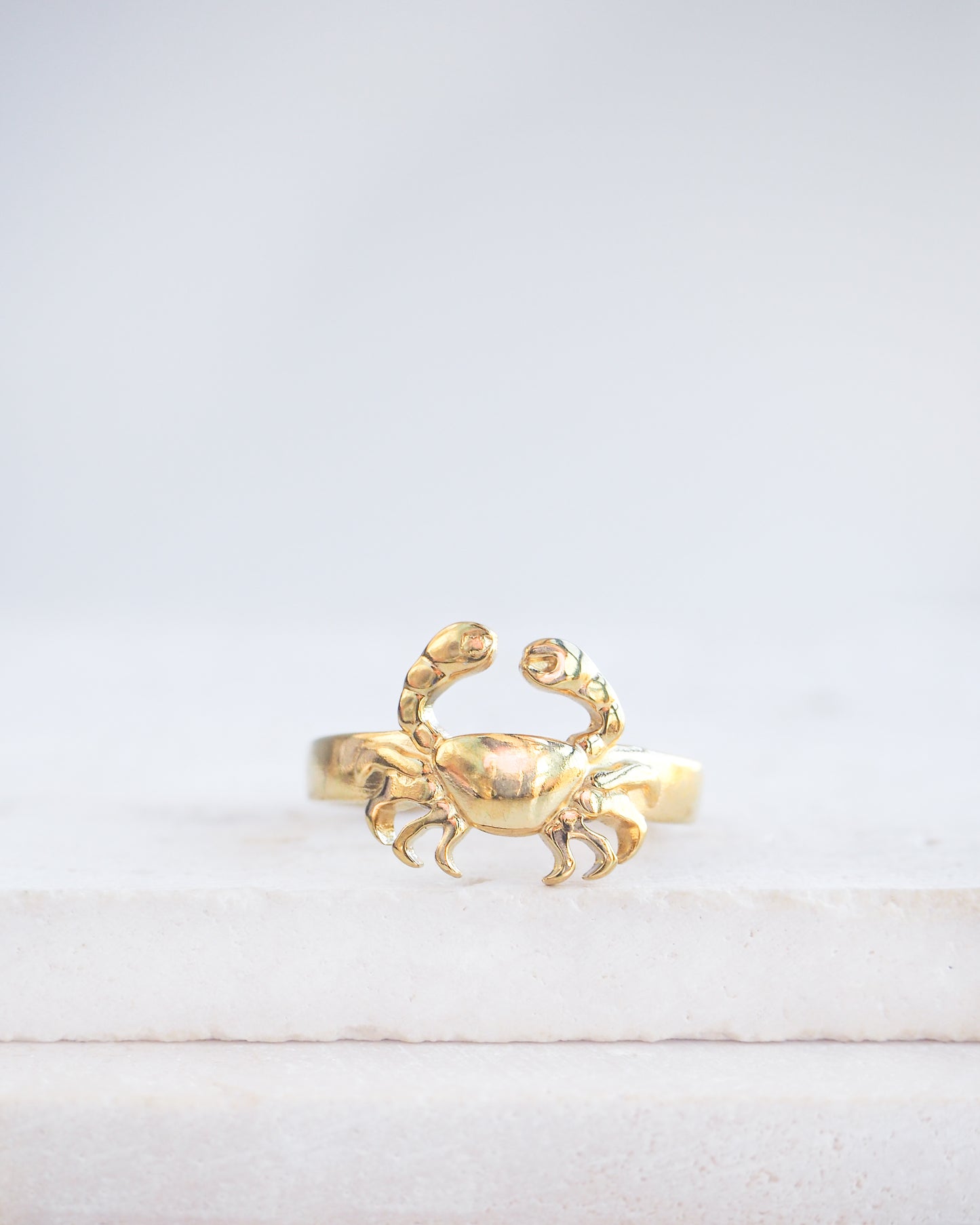 Gold Cancer Zodiac Ring on stone displayed, adjustable 18k gold stainless steel crab ring