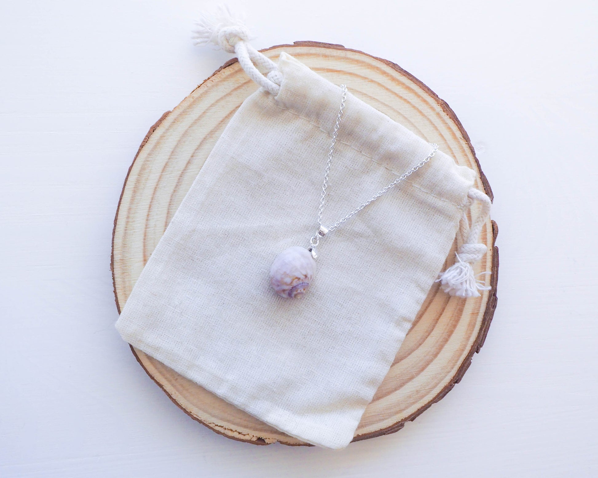 A detailed shot highlighting the delicate craftsmanship of the 925 silver setting, designed to accentuate the unique beauty of the Moon Shell.