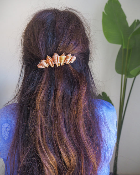 Person with long hair wearing a mediterranean cone shell hair clip against a neutral background.The shells are cone shaped with orange brown color. Handpicked from the beaches of Portugal. Boho Seashell Beach Clip from Portugal, Handpicked Real Shells, Seashell Hair Decoration, Bohemian Seashell Wedding Hair accessories, Coastal Christmas gift, Beach Wedding Hair