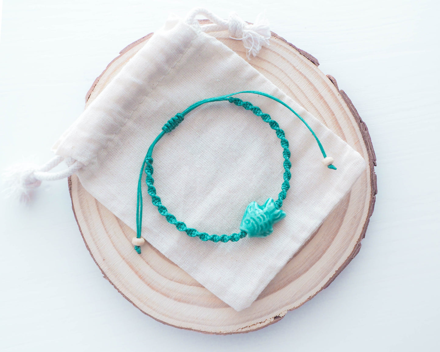 image showcasing the Fish Bracelet's adjustable chain and clasp, allowing for a customizable fit, coastal jewelry, ceramic turquoise fish bead, Ocean inspired accessoires, sea by lou