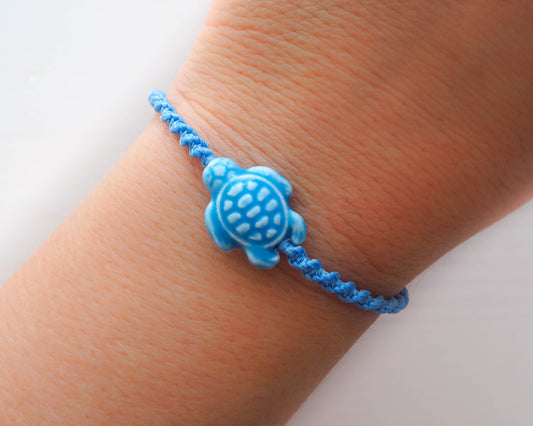Wearing Blue Ceramic Turtle Bracelet, made with wax cord and wooded beads, handmade in portugal