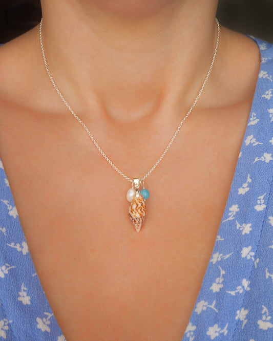Model wearing Elegant close-up of the white freshwater pearl pendant, symbolizing purity and timeless beauty in the Rustic Serenity Trio Necklace