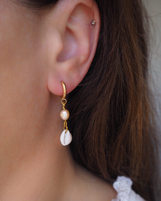 Model wearing Gold Cowrie Shell Earrings, Cowrie Seashell Earrings with Rose Freshwater Pearls, Handmade from Portugal, Real Seashells, Cowrie shell earrings, Shell earrings, Shell hoops, Cowrie Boho earrings, Beach earrings